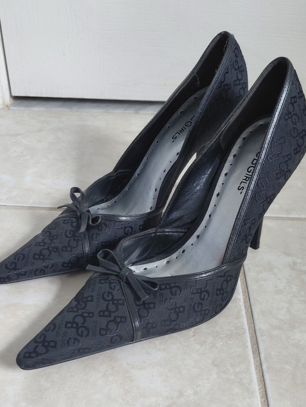 BCBGirls Black Monogram Pointed Toe Bow Heels